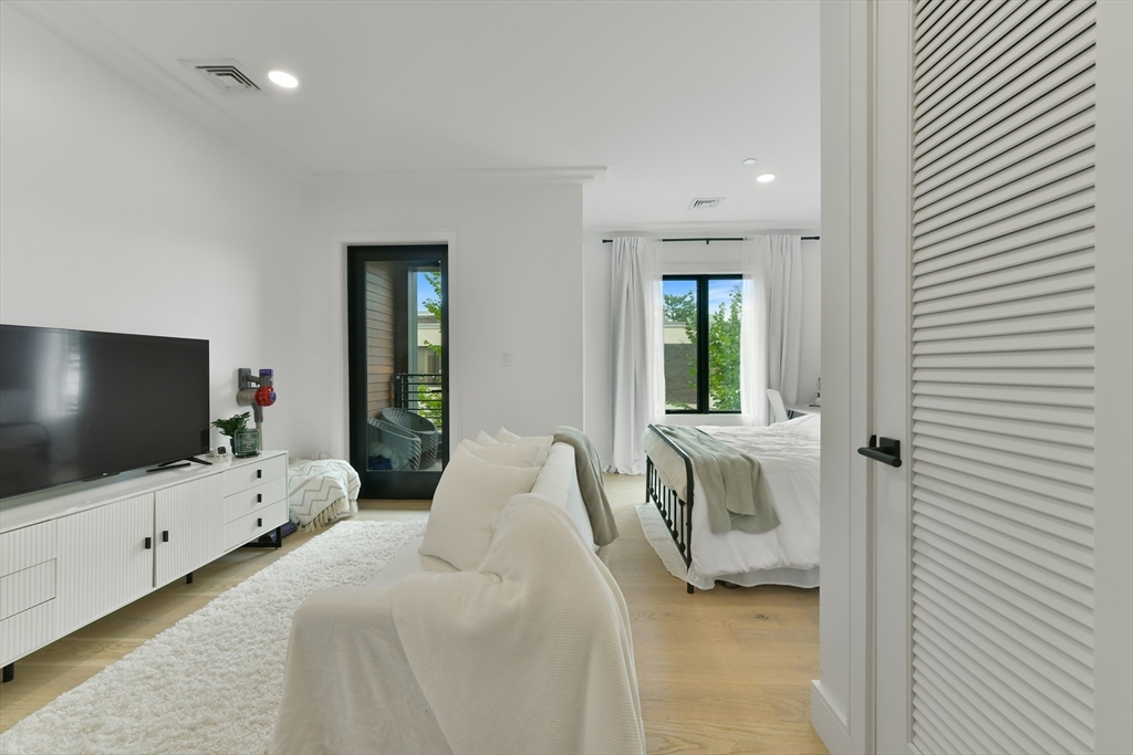 a bedroom with furniture and a flat screen tv