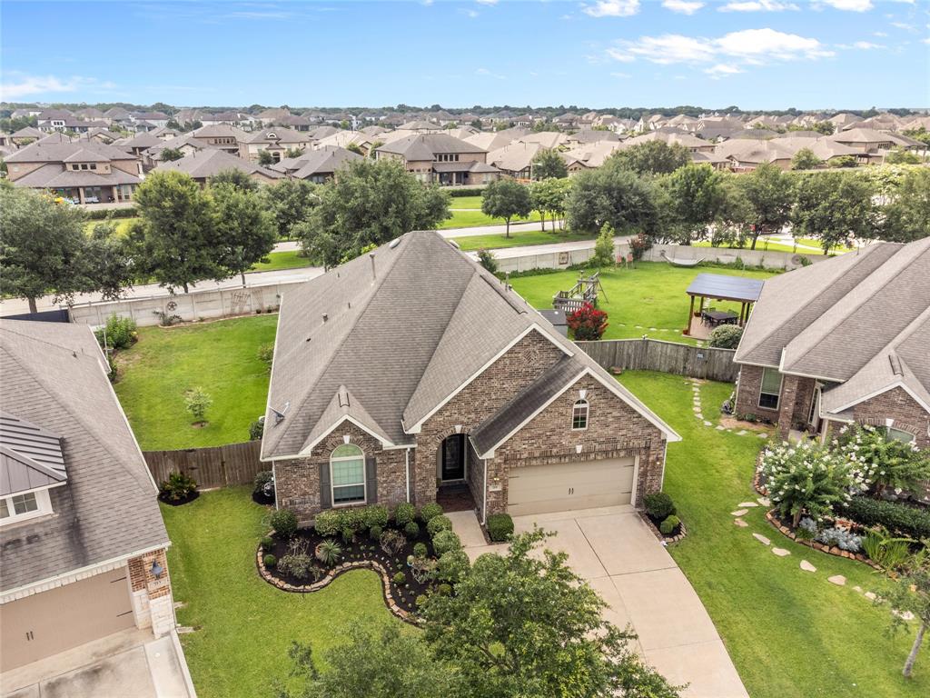 an aerial view of a house with a big yard