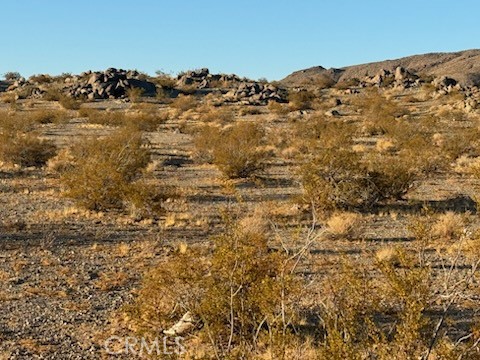 a view of a large building with mountains in the background