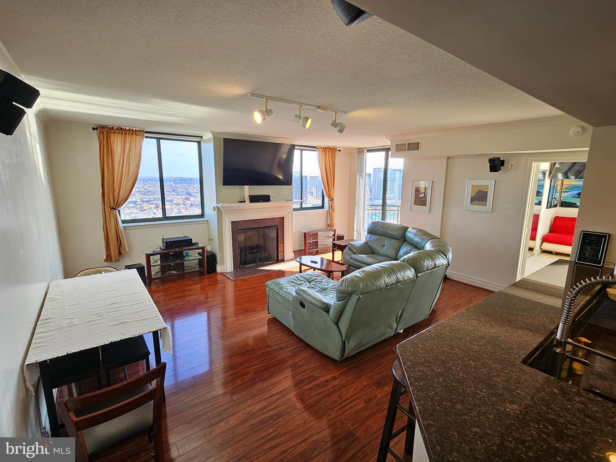 a living room with furniture a flat screen tv and a fireplace