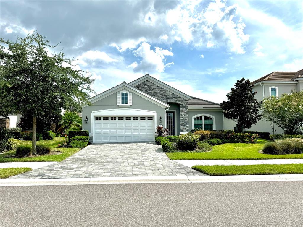 a view of a house with a big yard plants and large trees