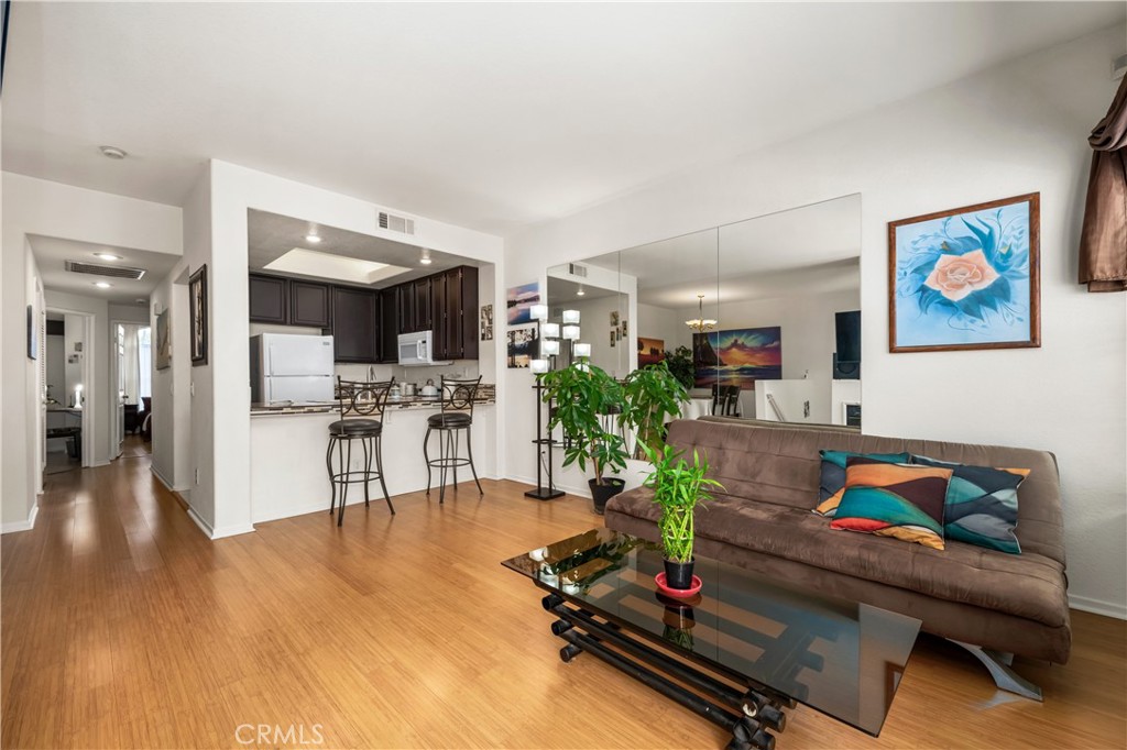 a living room with furniture and kitchen view