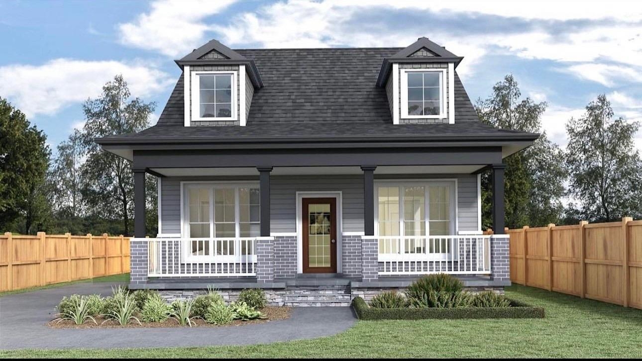 a front view of a house with a garden