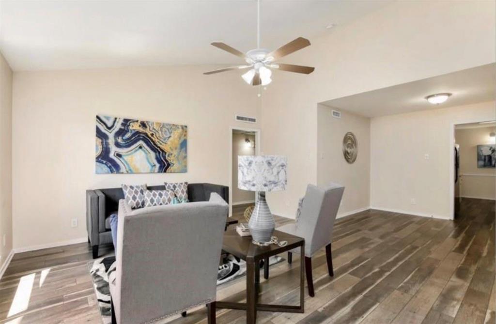 a dining room with furniture and a chandelier