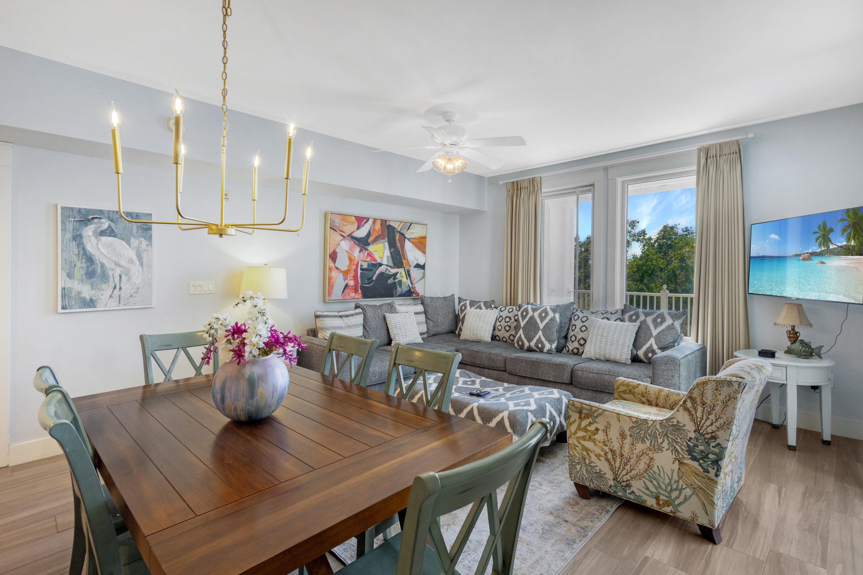 a living room with furniture kitchen view and a large window