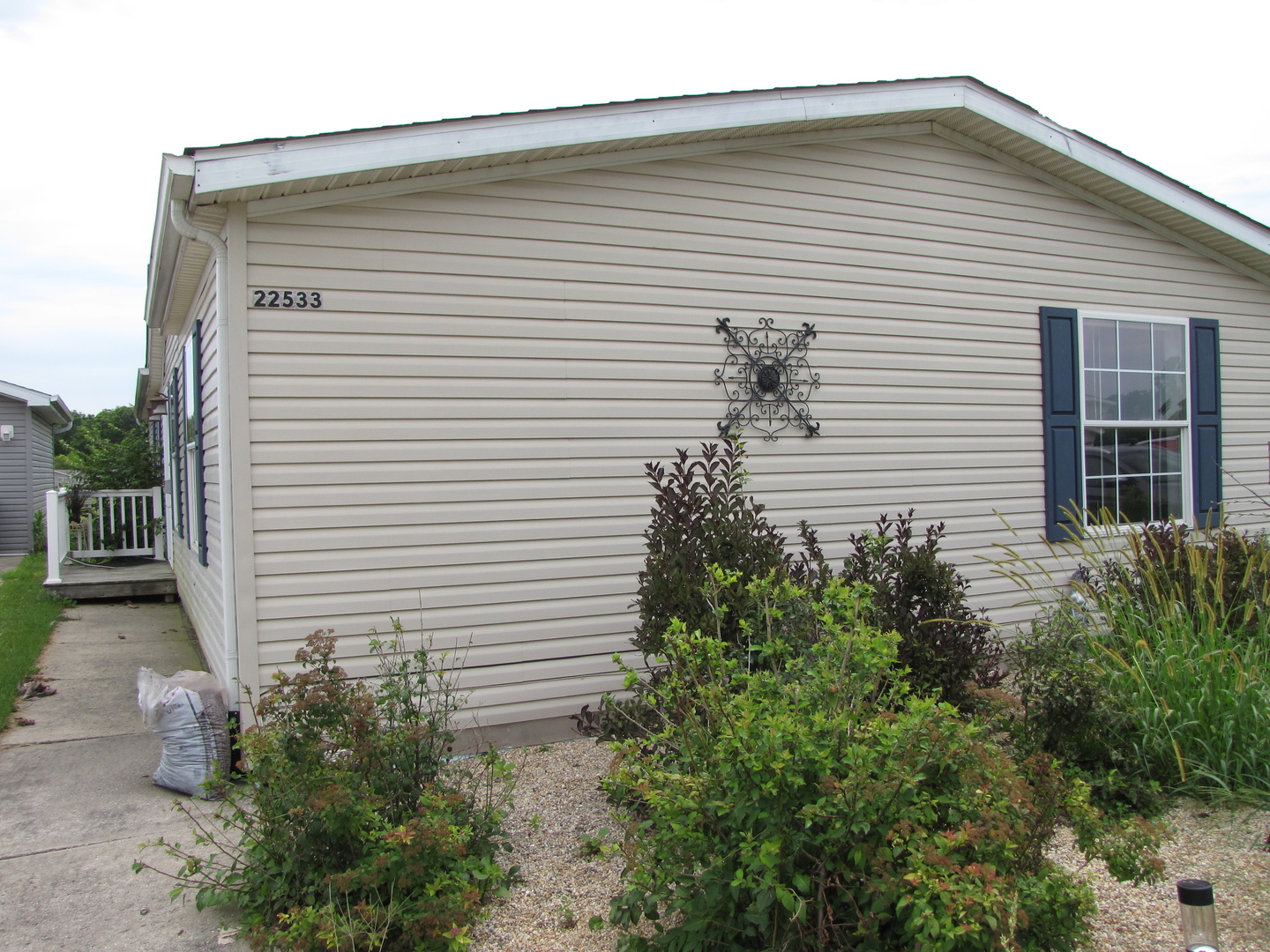 a front view of a house with plants