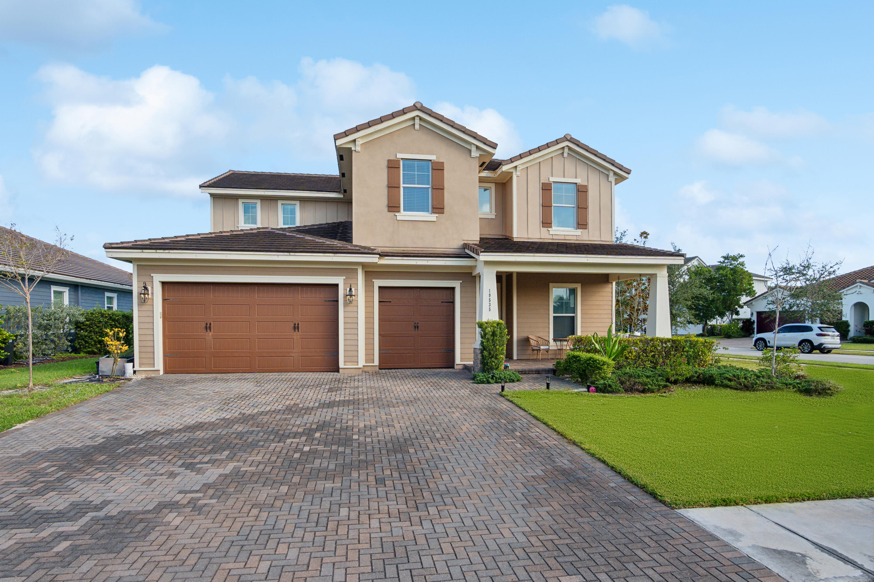 a front view of a house with a yard and garage