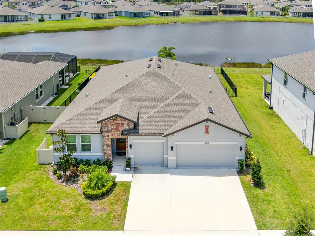 an aerial view of a house with a swimming pool