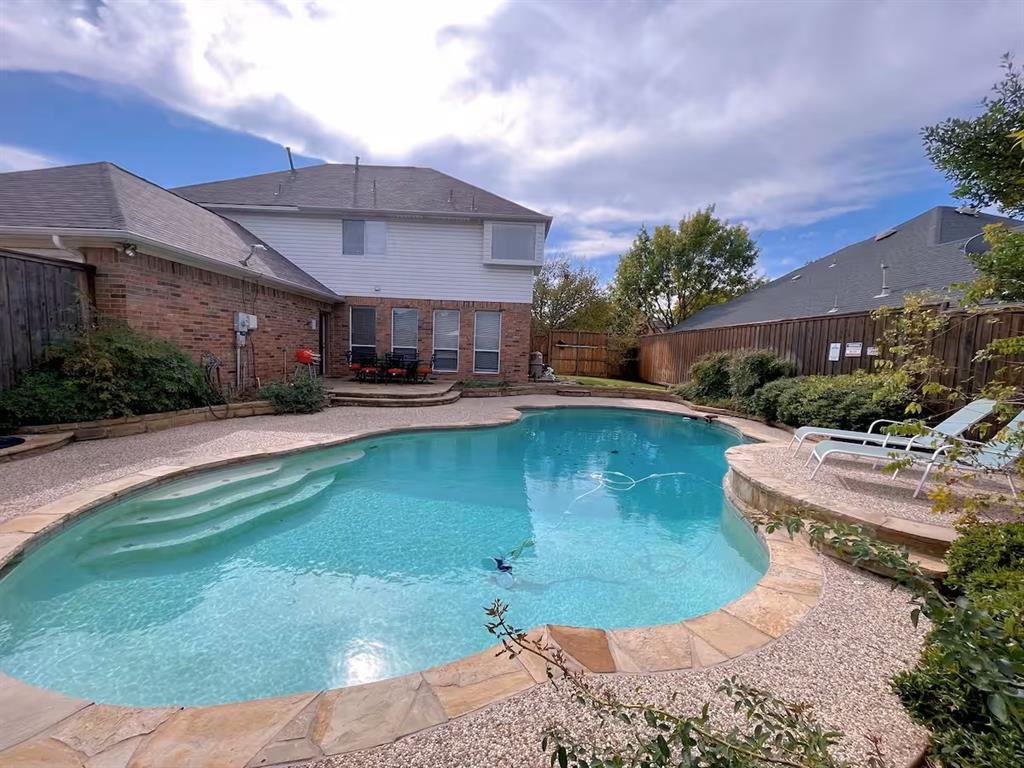 a swimming pool with outdoor seating and yard