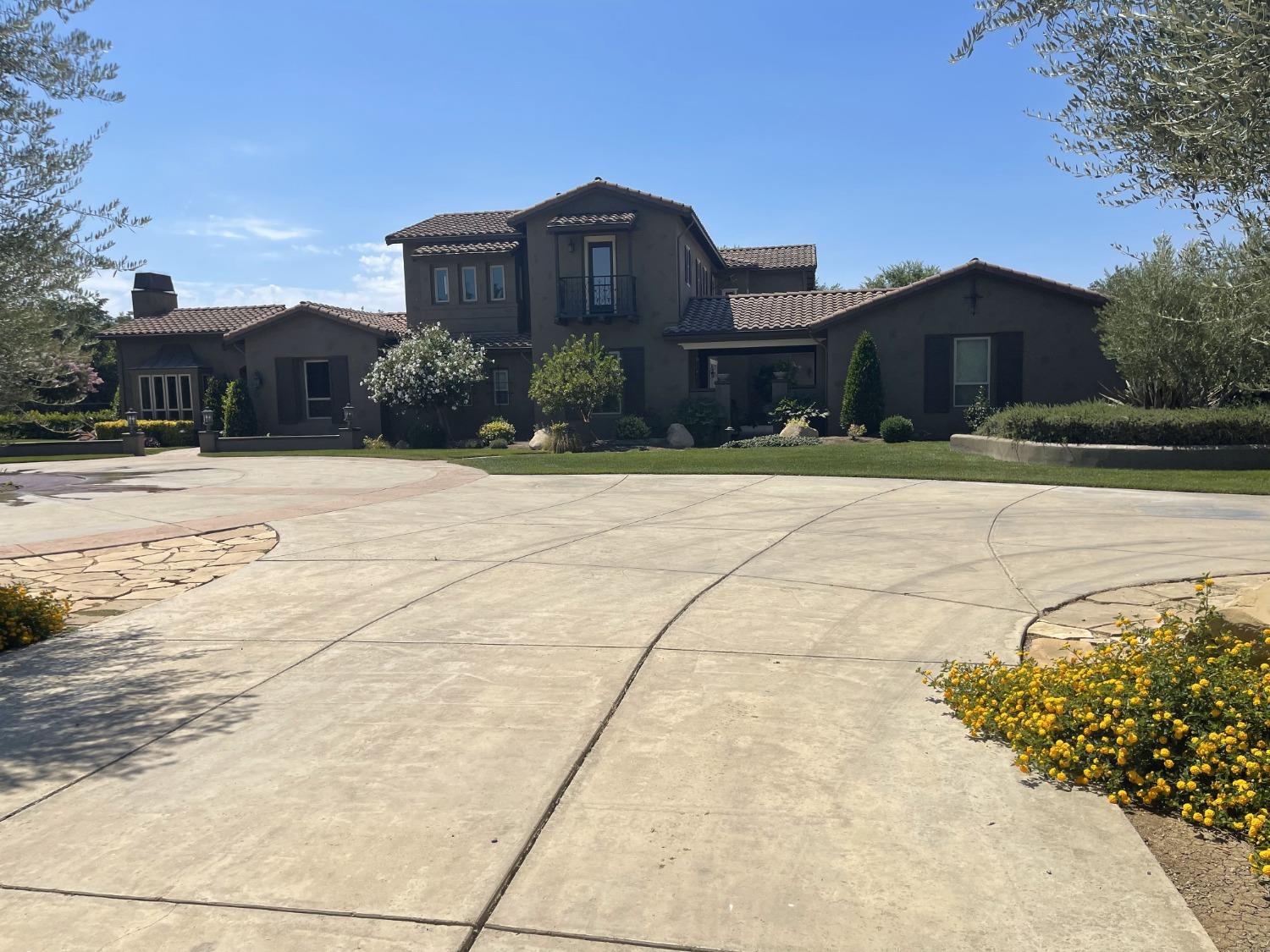 a front view of a house with a yard and a garage