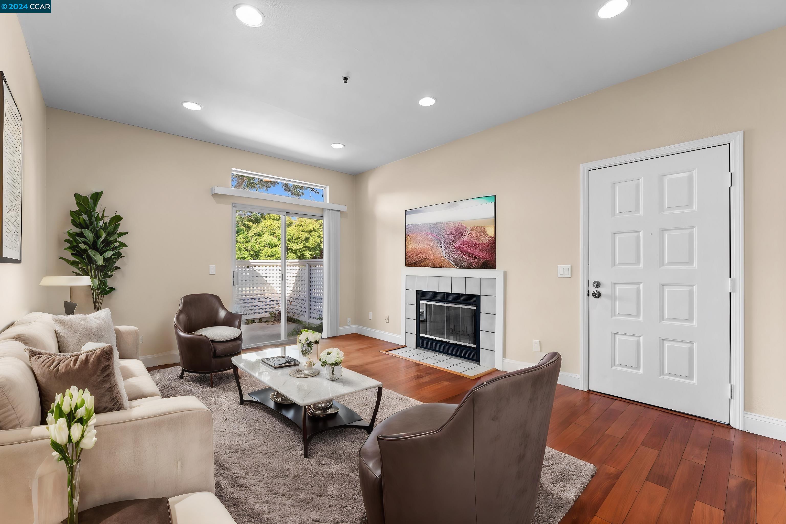 a living room with furniture flat screen tv and fireplace