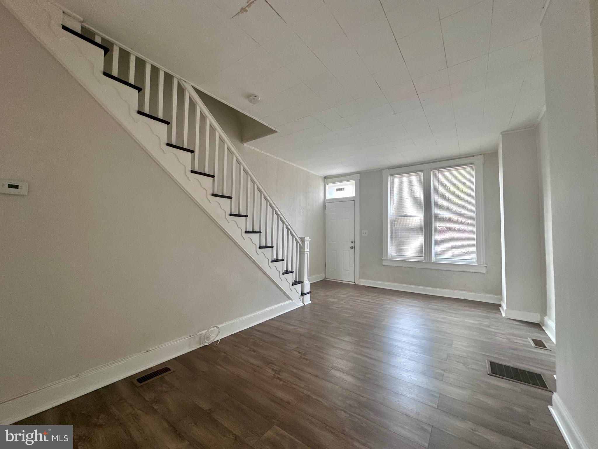 a view of an entryway with wooden floor