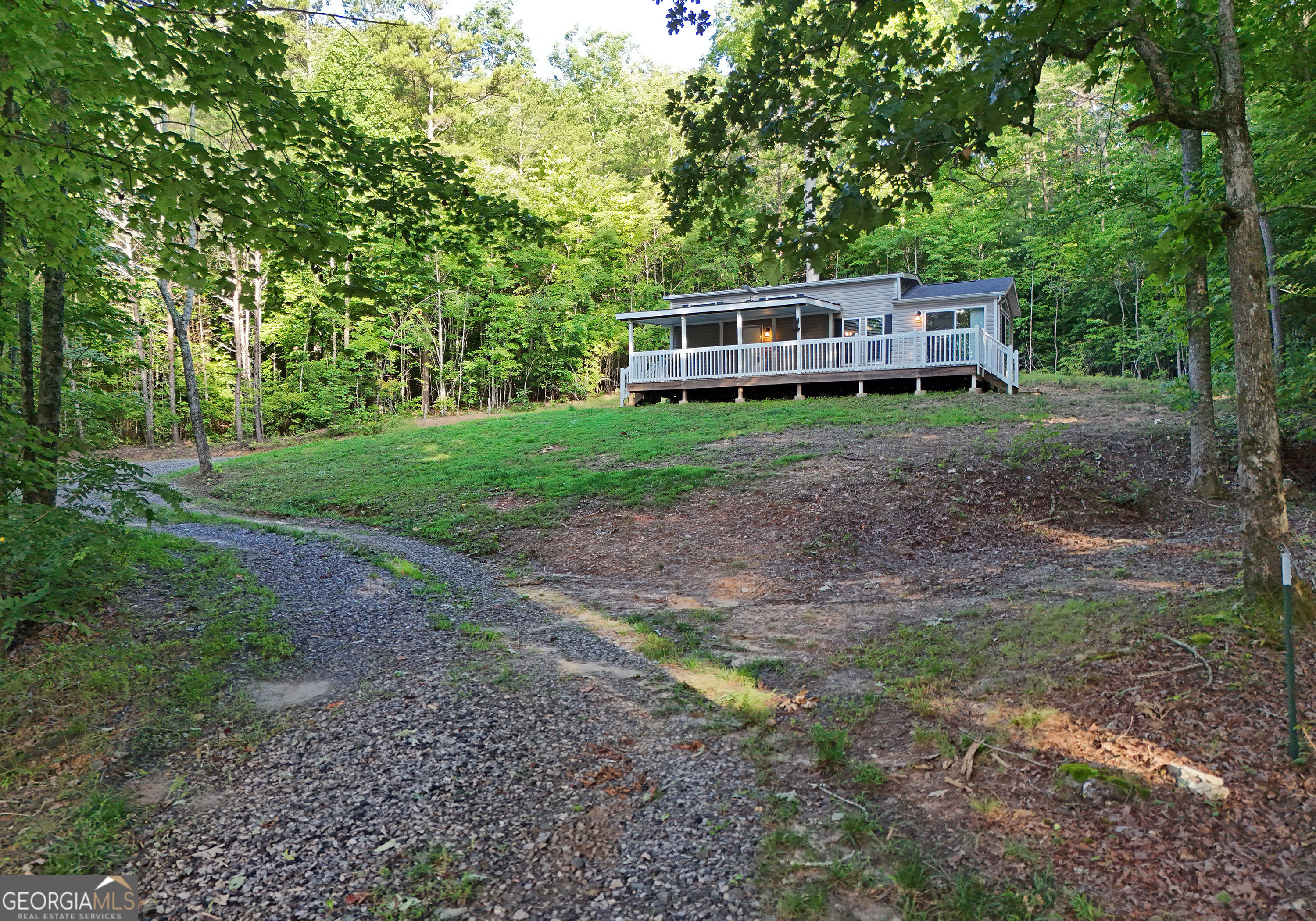 a view of a house with yard and sitting area