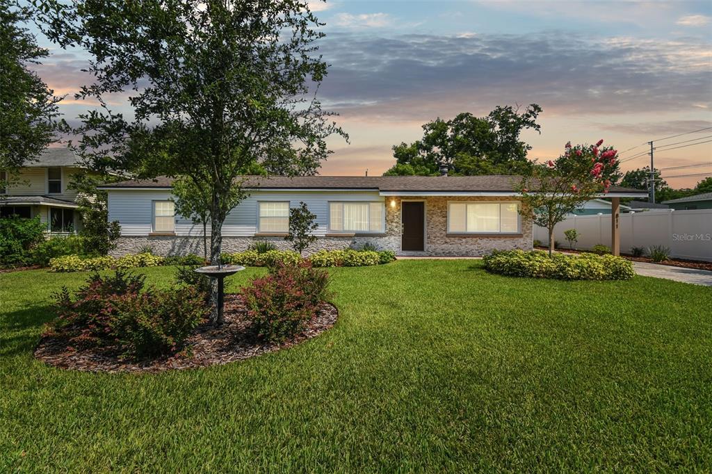 a front view of house with yard and green space