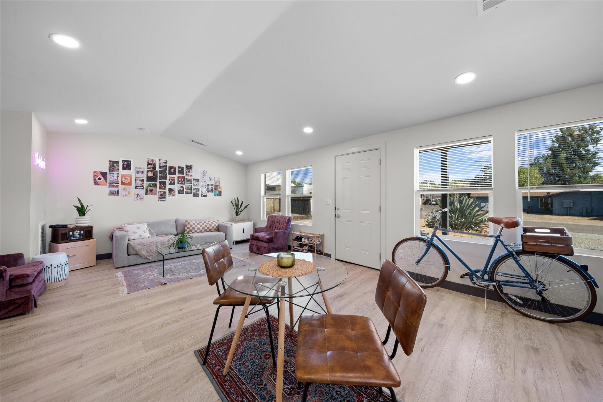 a living room with furniture a rug and a wooden floor