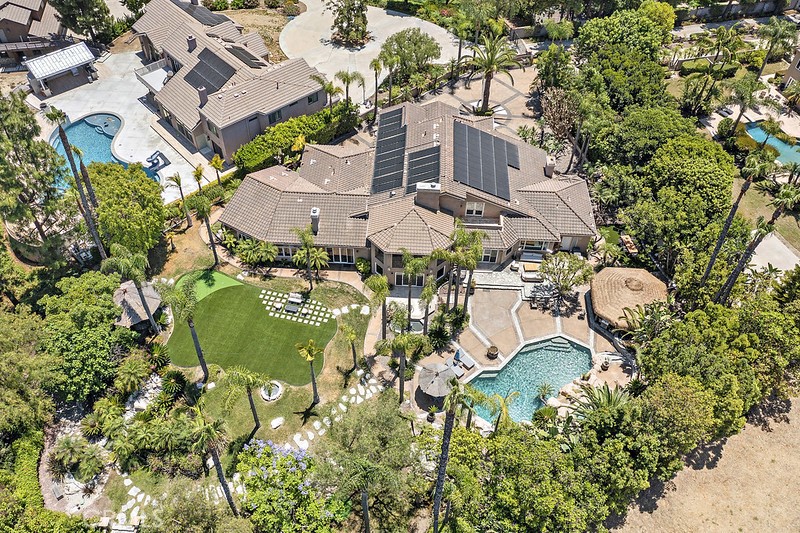 an aerial view of multiple houses with yard