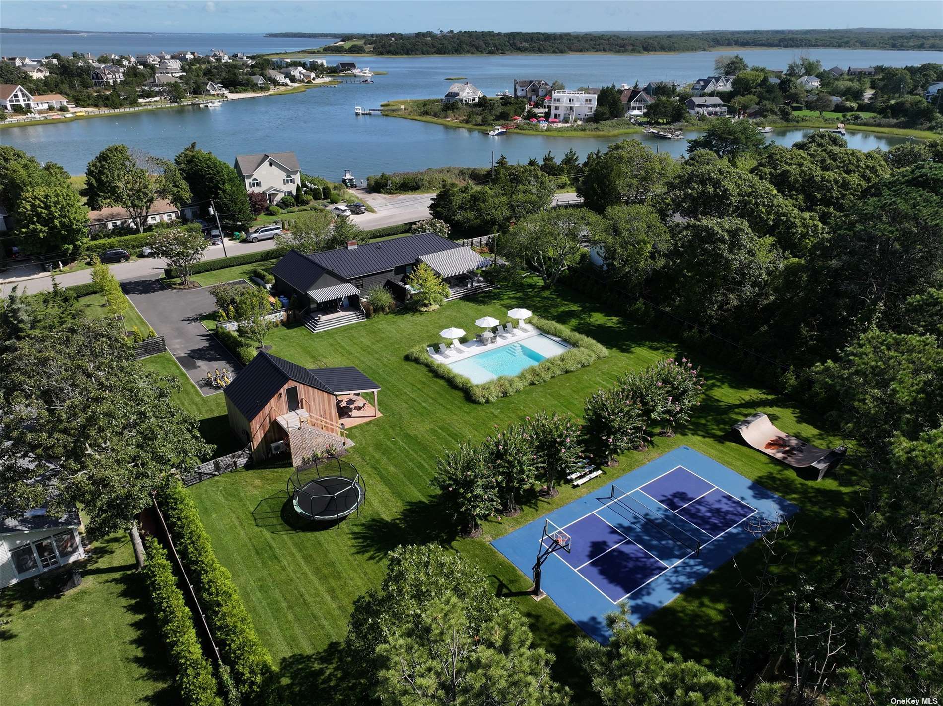 an aerial view of residential houses with outdoor space and river