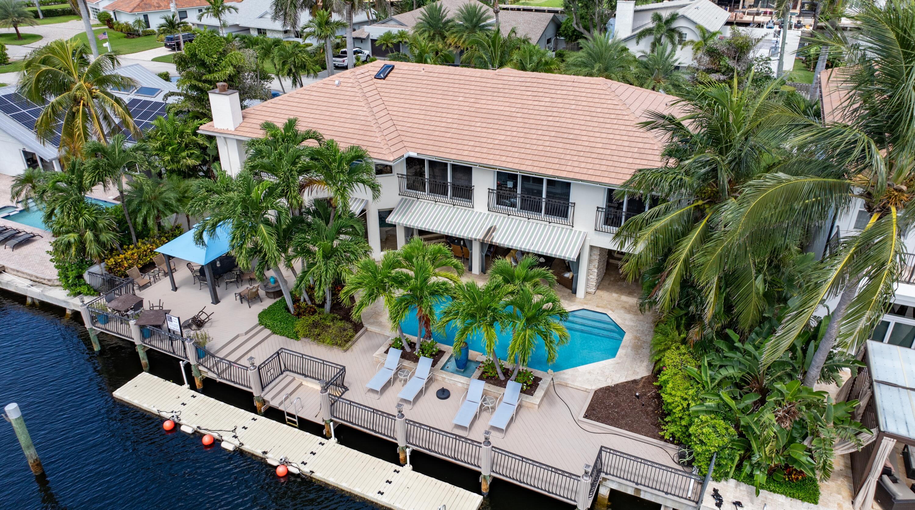 an aerial view of a house with balcony and garden