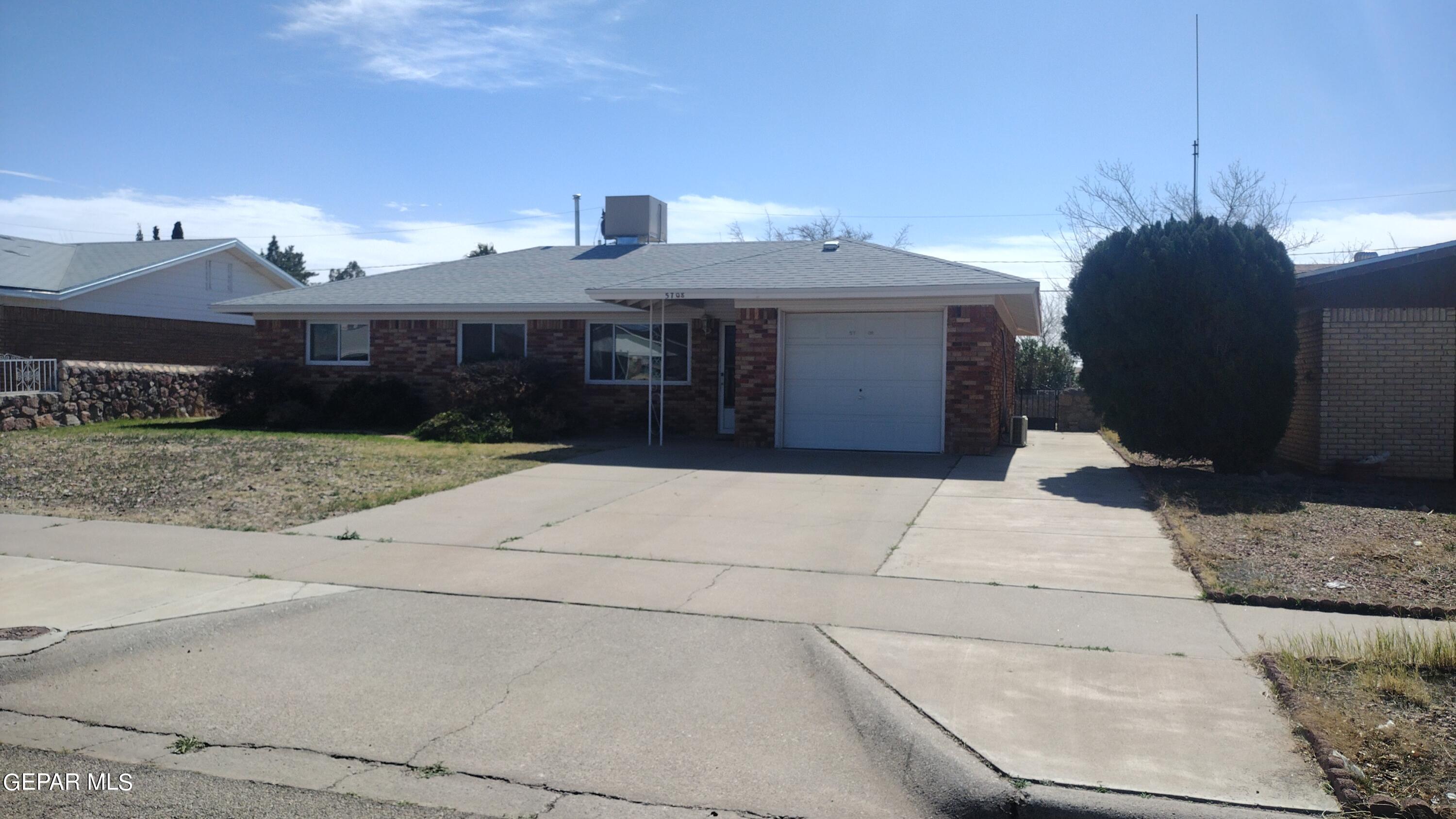 a front view of house with a garden