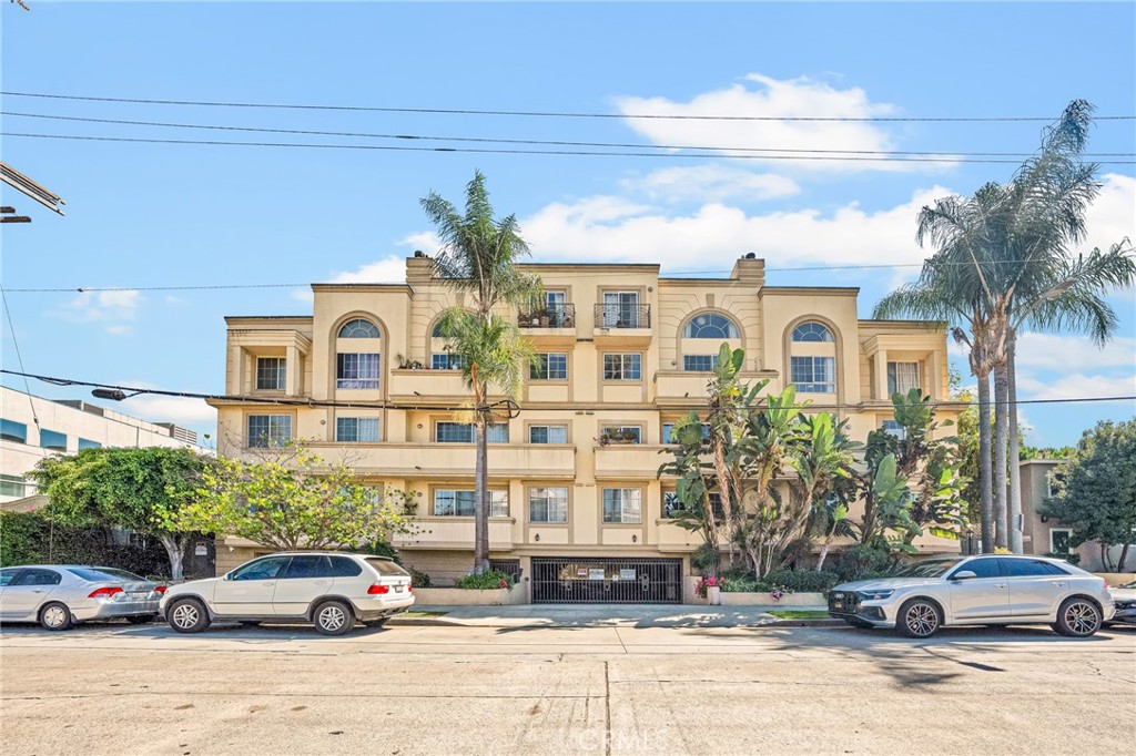 a front view of a residential apartment building with a yard