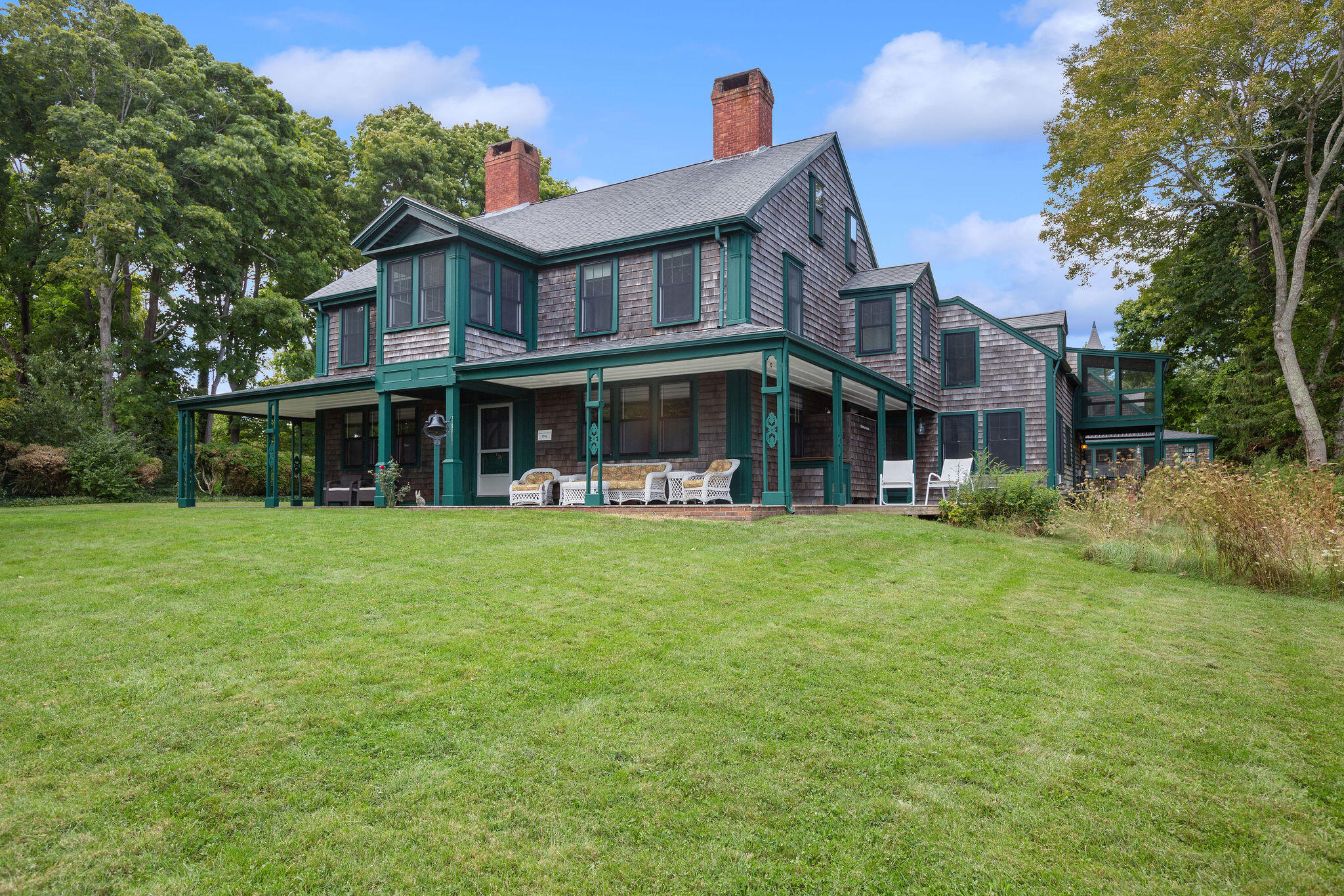 front view of a brick house with a yard