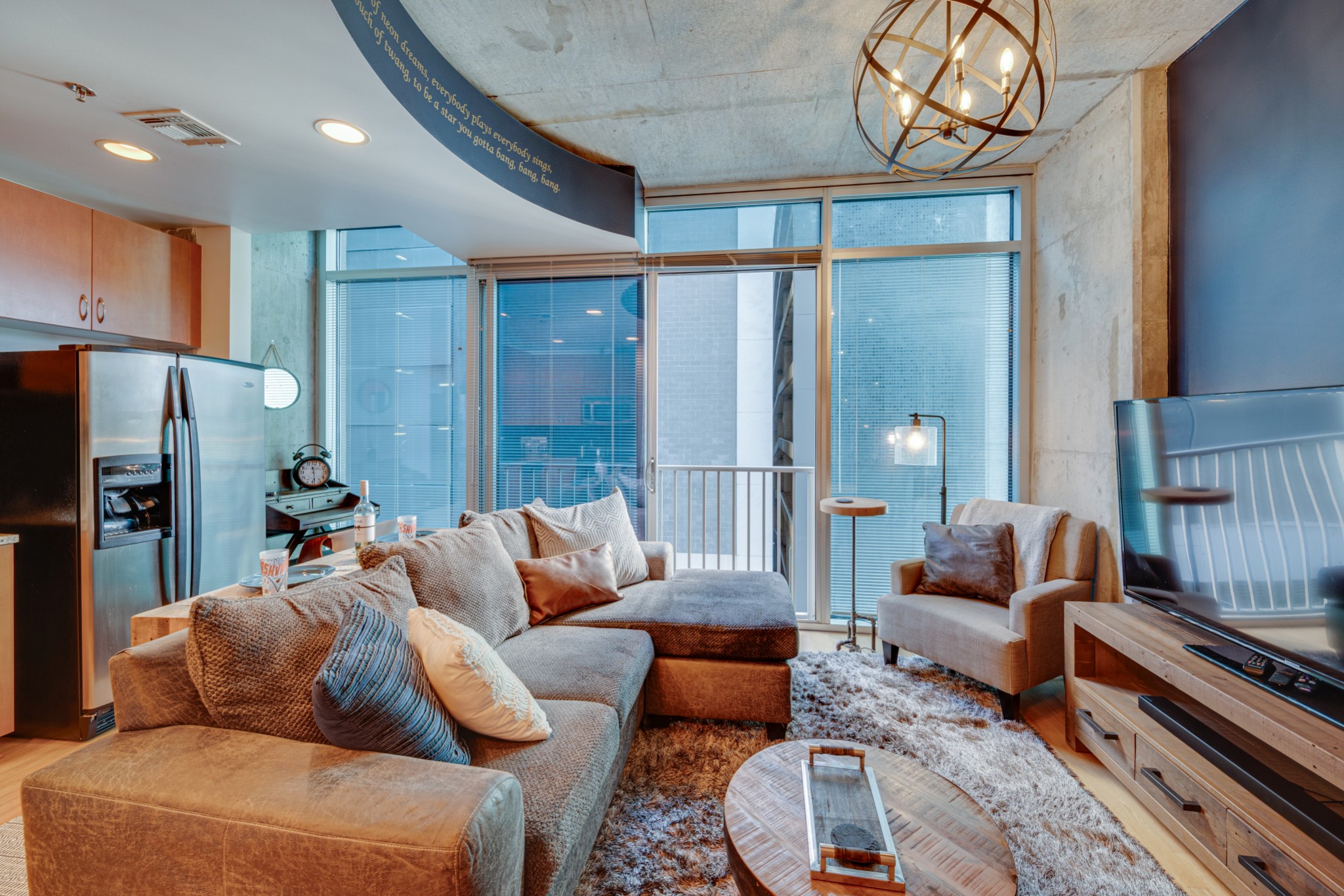 a living room with furniture a fireplace and a chandelier