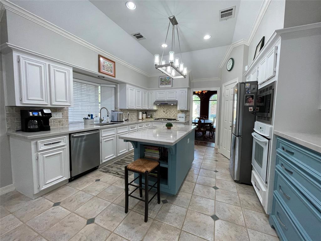 GORGEOUSLY RENOVATED KITCHEN WITH QUARTZ COUNTERS, WHITE CABINETS AND RECESSED LIGHTING