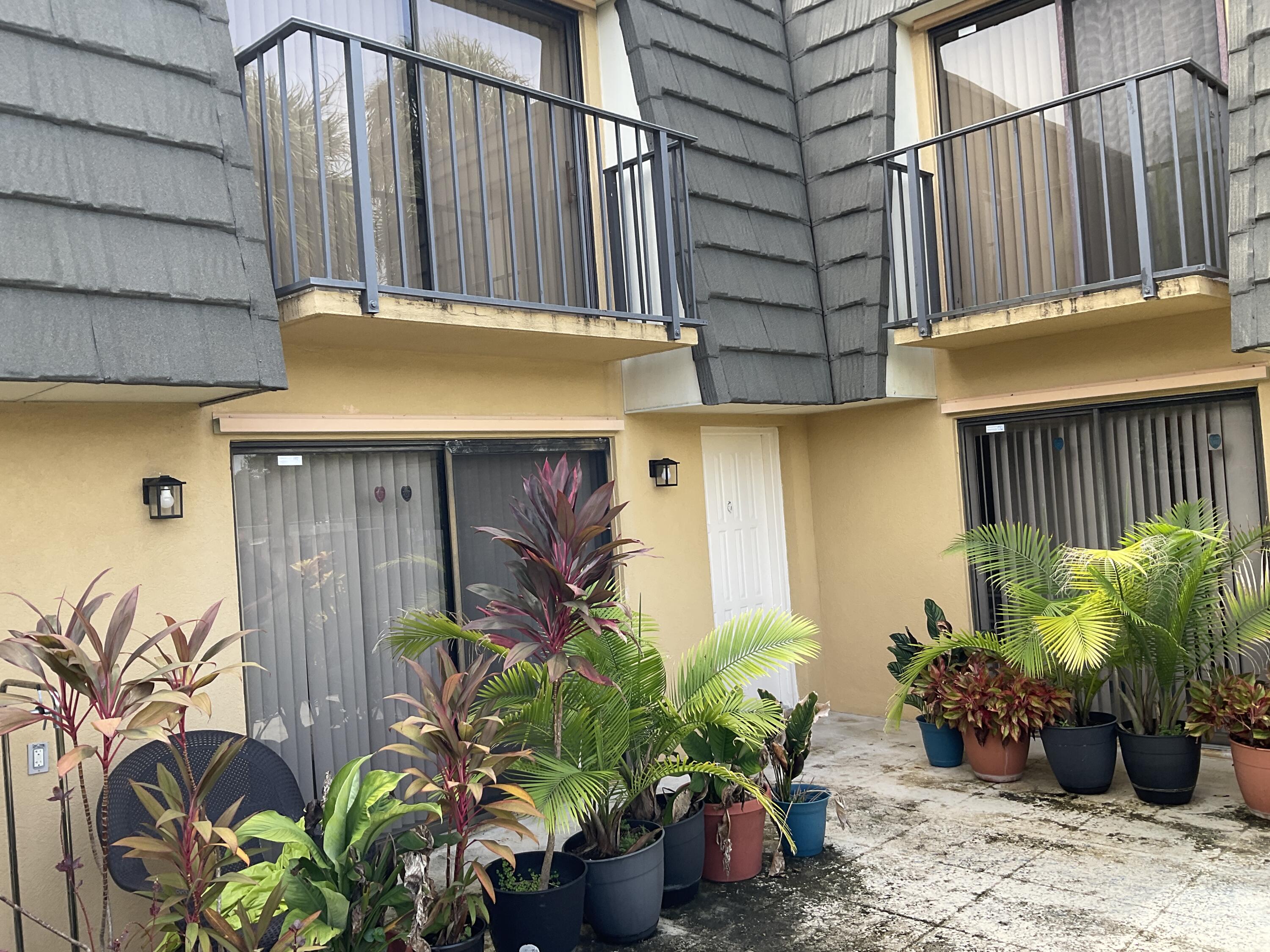 a view of a house with potted plants