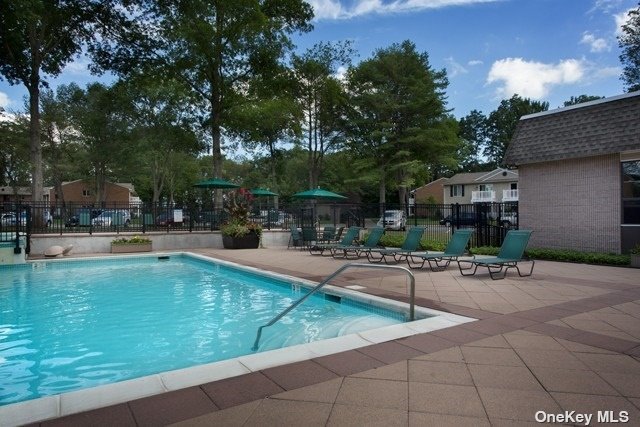 a swimming pool with outdoor seating and yard