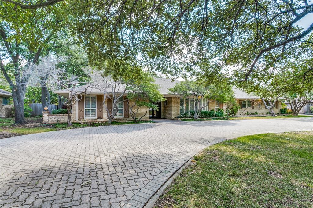 a front view of a house with a yard and fountain