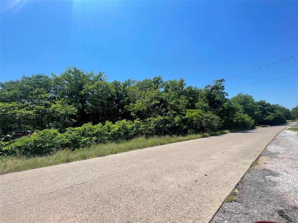 a view of a road with a garden