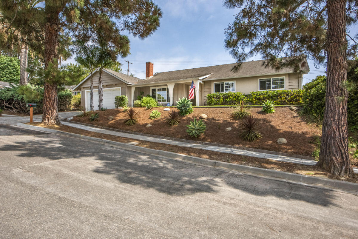 a front view of a house with yard