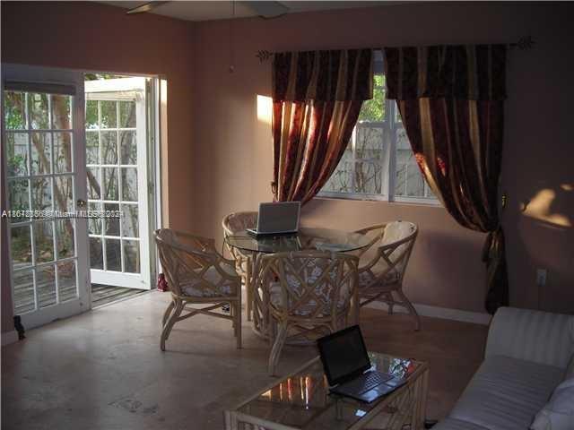 a dining room with furniture and window