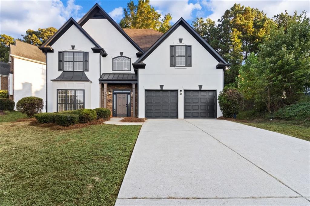 a front view of a house with a yard and garage