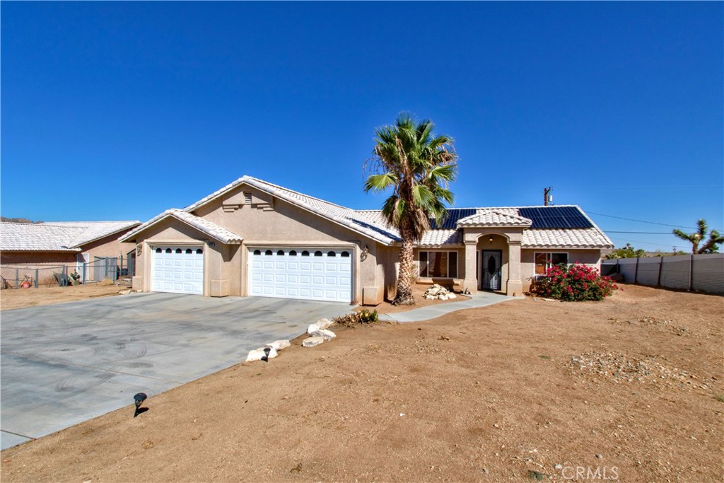 a big house with palm trees in front of it