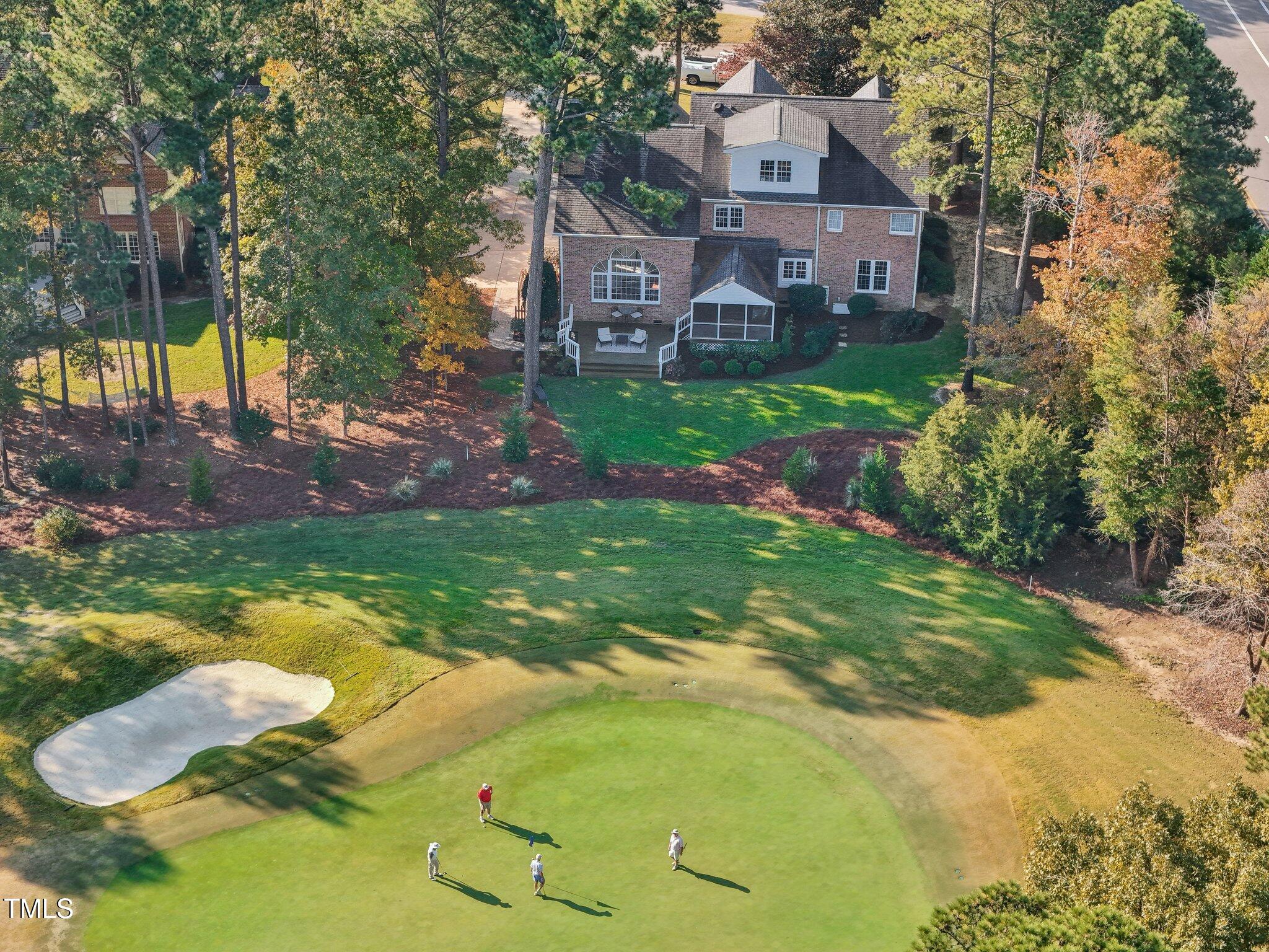 a aerial view of a house with a yard table and chairs