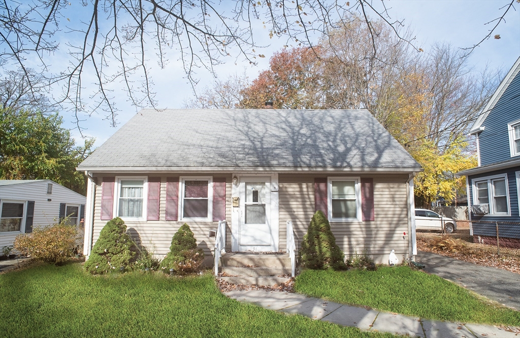 a front view of house with yard and green space