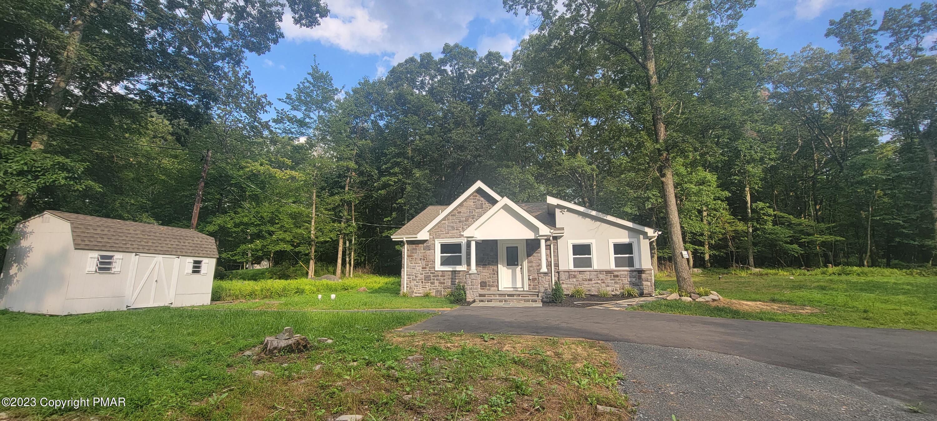 a view of a house with yard and a garden