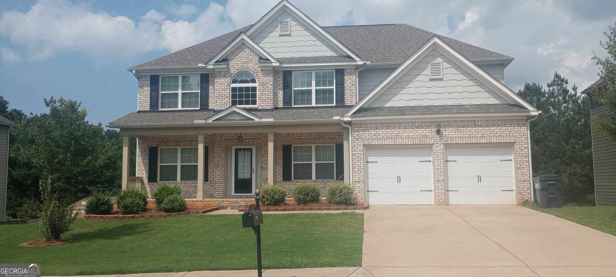 front view of a house with a yard