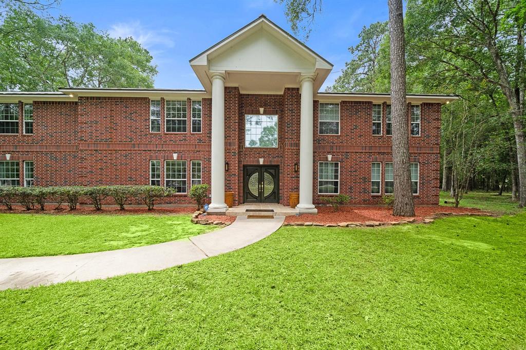 Elegant two-story home at 21992 Blazing Trail, surrounded by trees