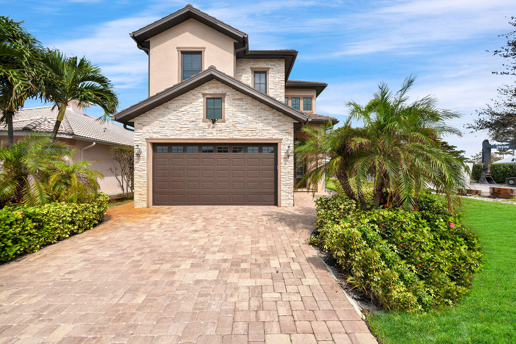 a front view of a house with a yard and a garage