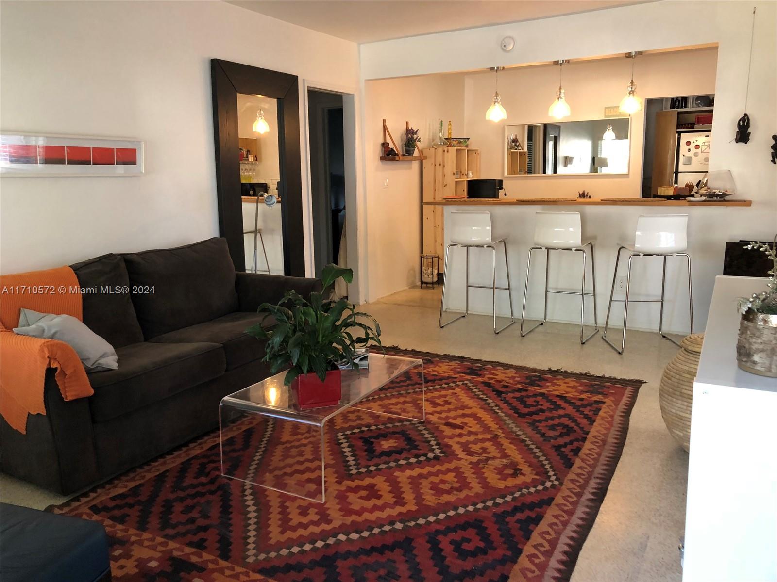 a living room with furniture and a rug