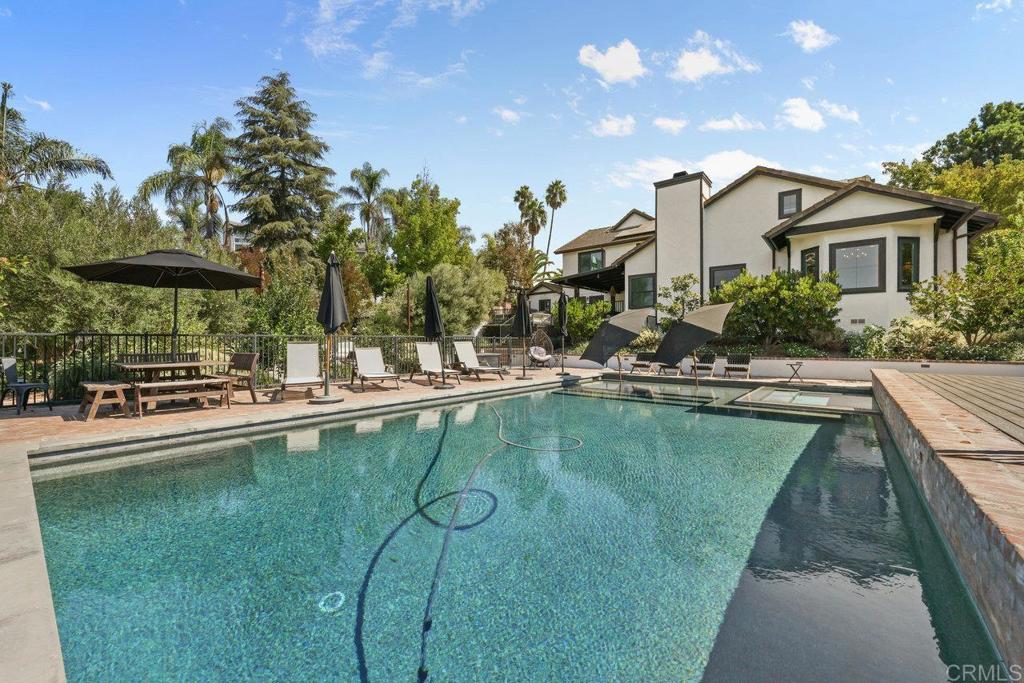 a view of a house with swimming pool and sitting area