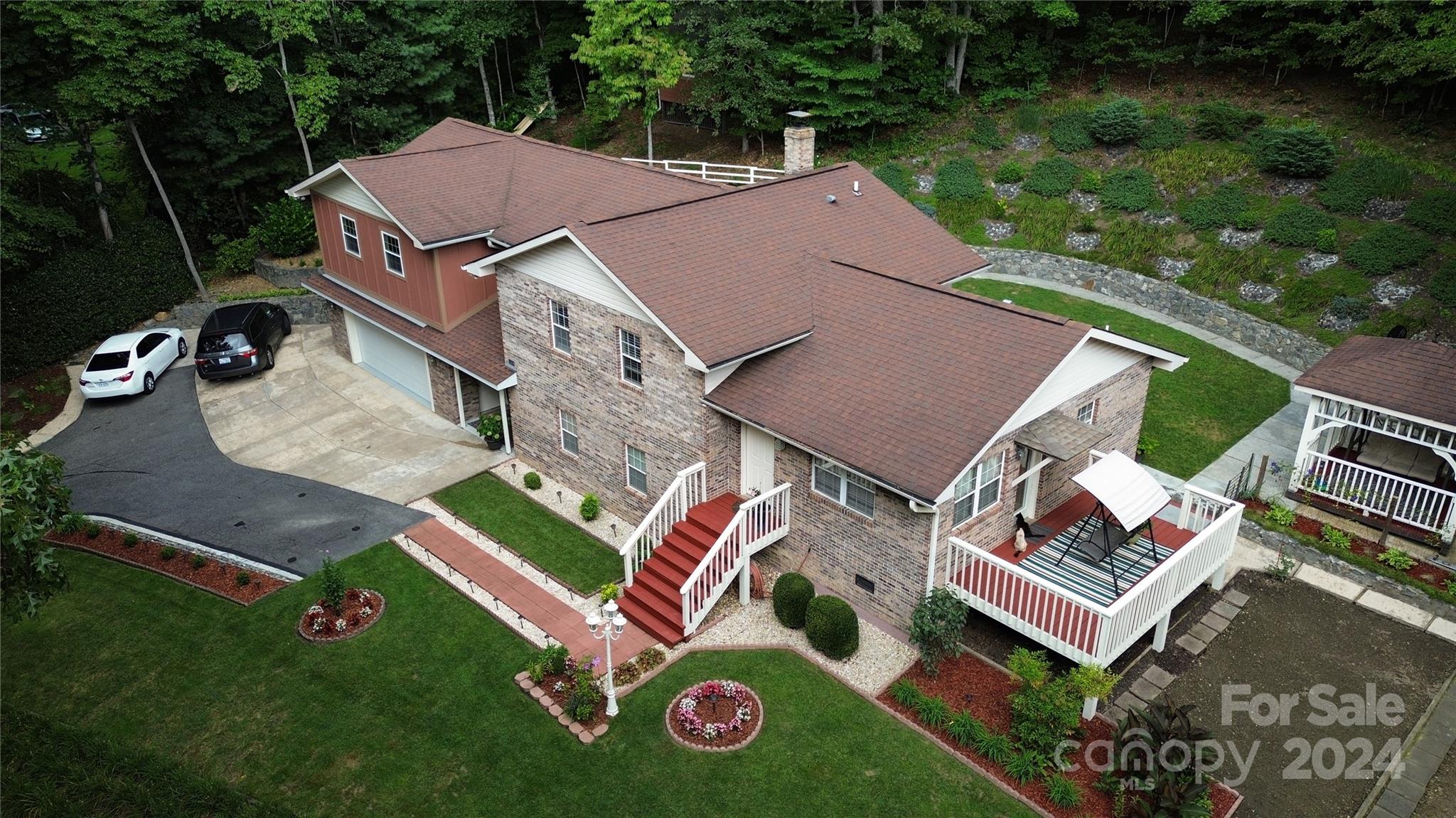 an aerial view of a house with garden space and street view