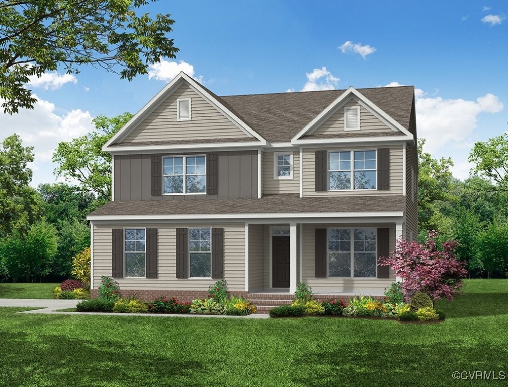 a front view of a house with a yard and plants