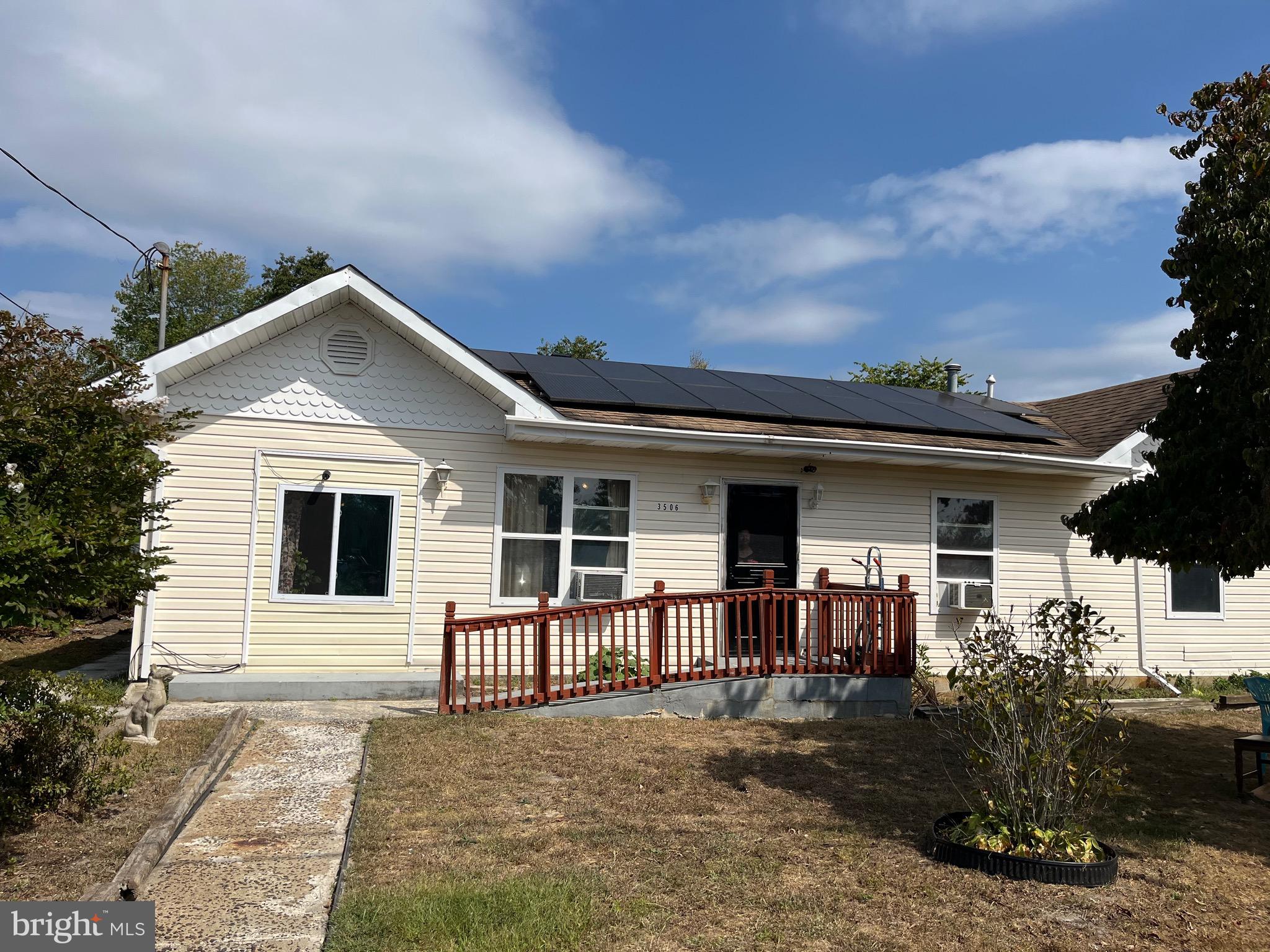 a front view of a house with yard and parking space