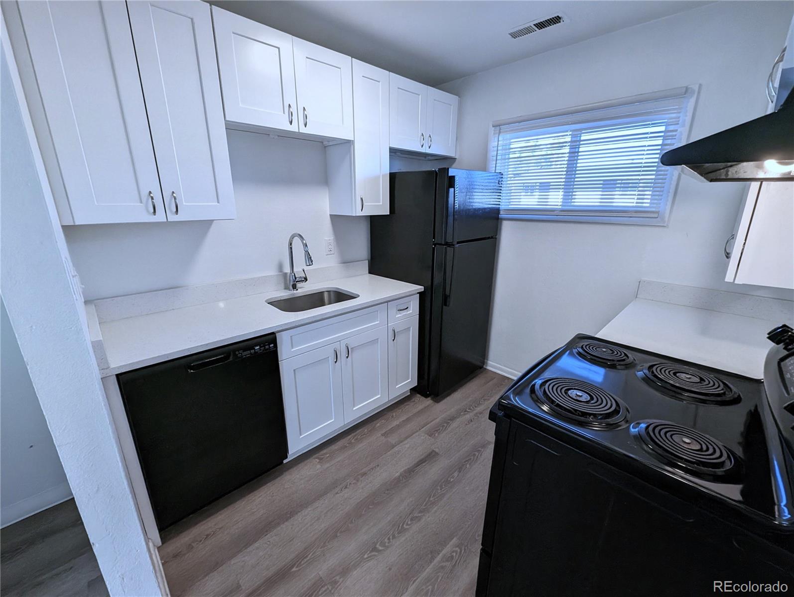 a kitchen with a stove and a refrigerator