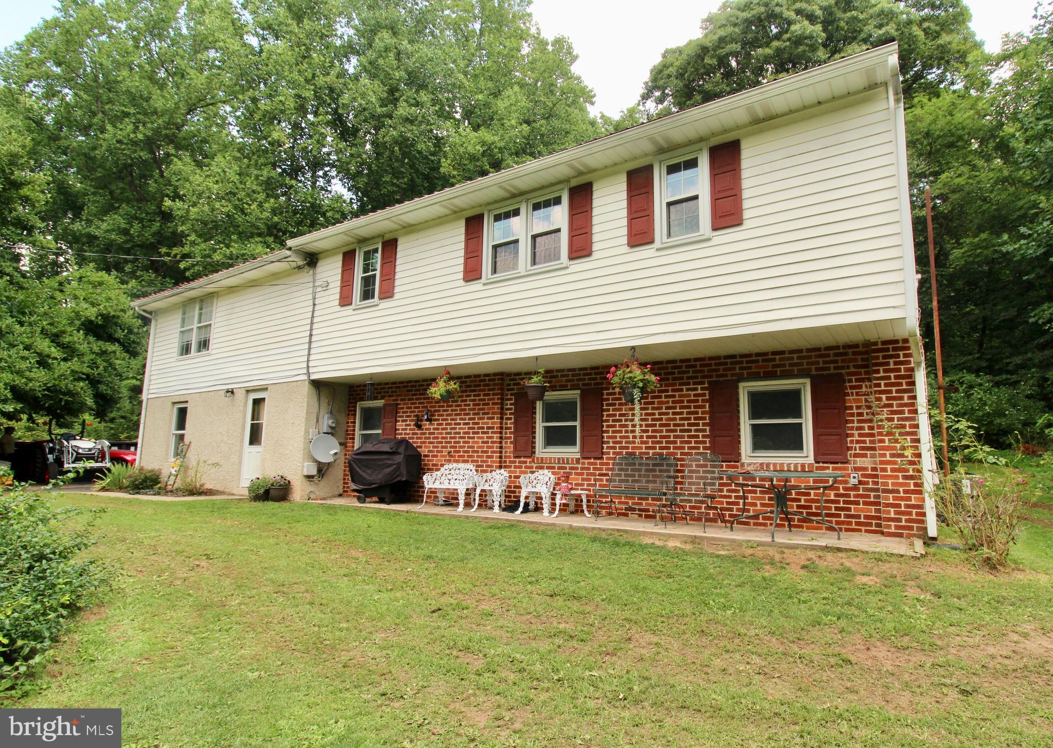 a front view of house with yard and outdoor seating