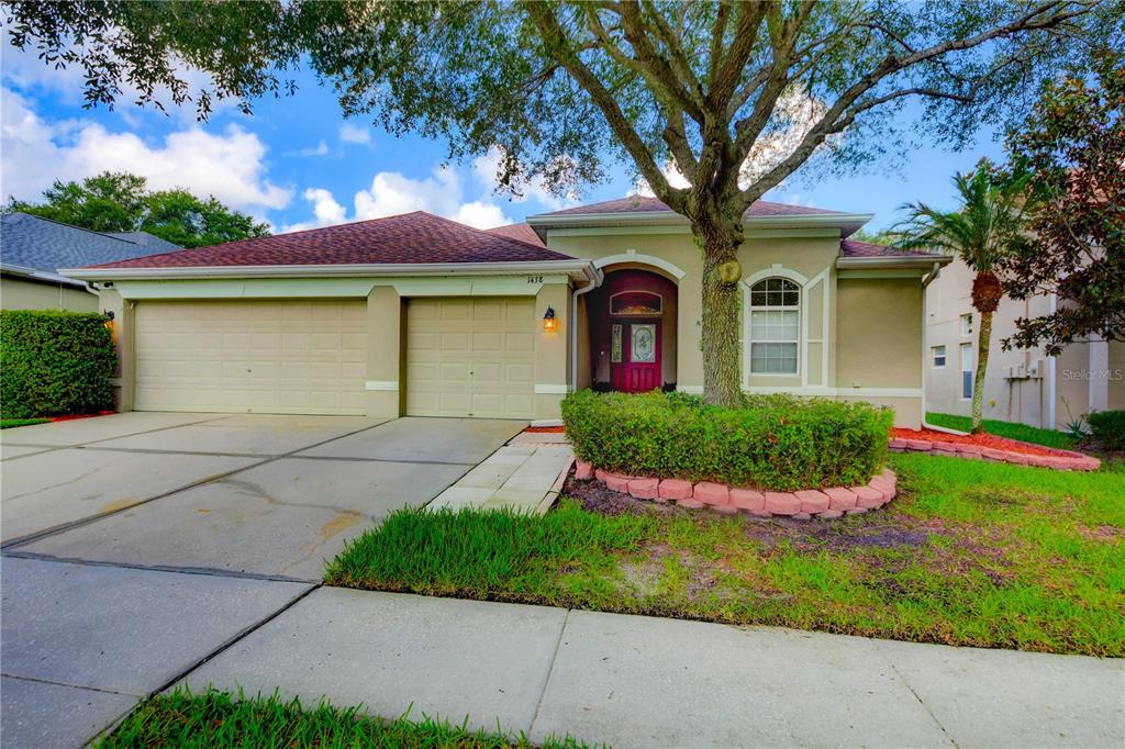 a front view of a house with a yard and garage