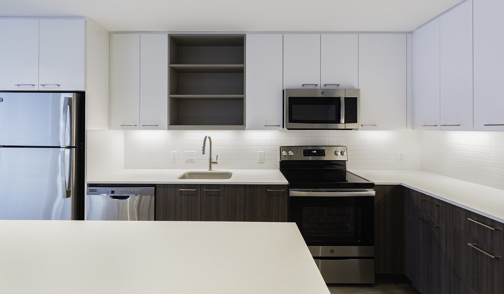 a kitchen with a sink and a stove top oven